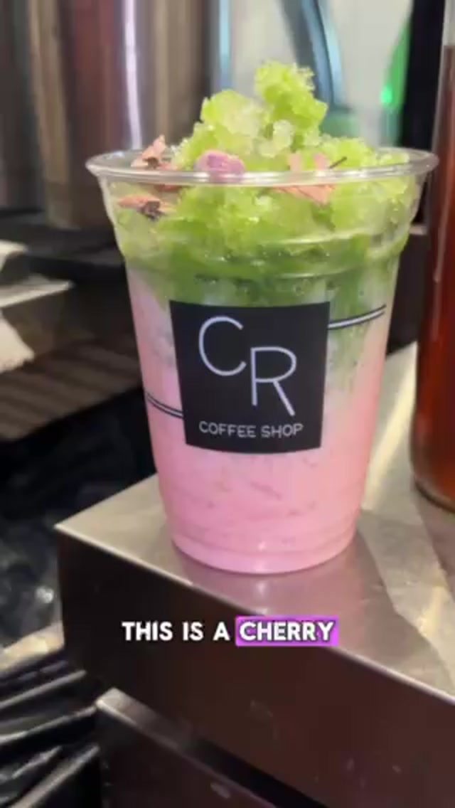 Cherry Blossom Matcha at CR Coffee Shop with pink cherry blossom milk, green matcha, and dried cherry blossoms on top
