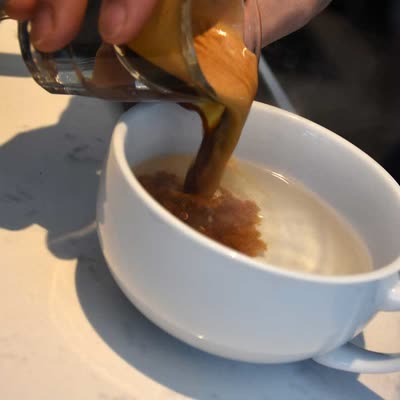 An Americano in a CR cup on the counter