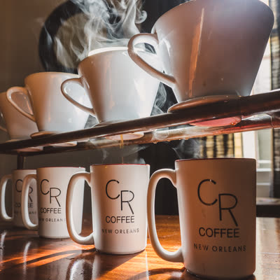 Steaming mugs of drip coffee