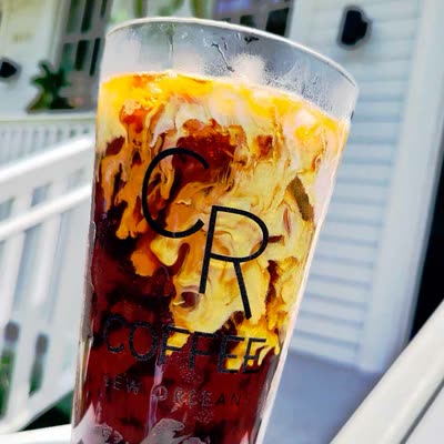 Sweet Vanilla Cream Cold Brew in a glass, the cream float sinking into the cold brew