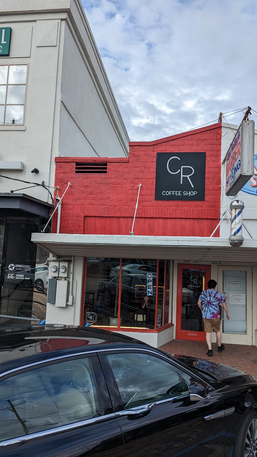 The red brick storefront on Metairie Road in daylight, CR Coffee Shop sign above the awning