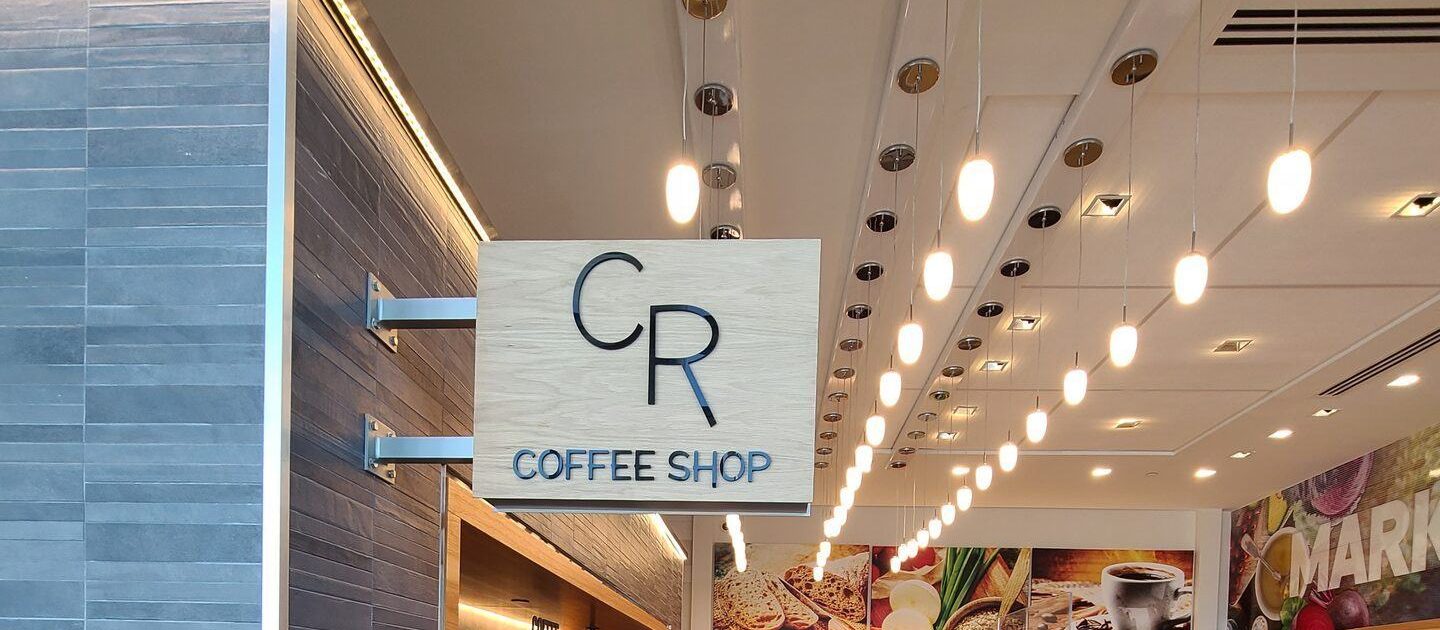 CR Coffee Shop kiosk sign inside MSY Airport