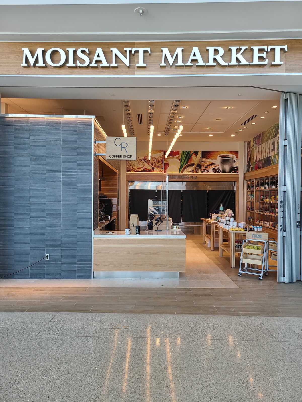 The Moisant Market entrance at MSY with the CR Coffee sign inside