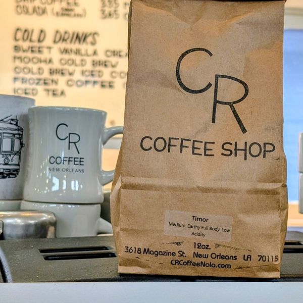 A 12-ounce CR Coffee bag of Timor single origin on the counter at Magazine Street, labeled medium, earthy full body, low acidity