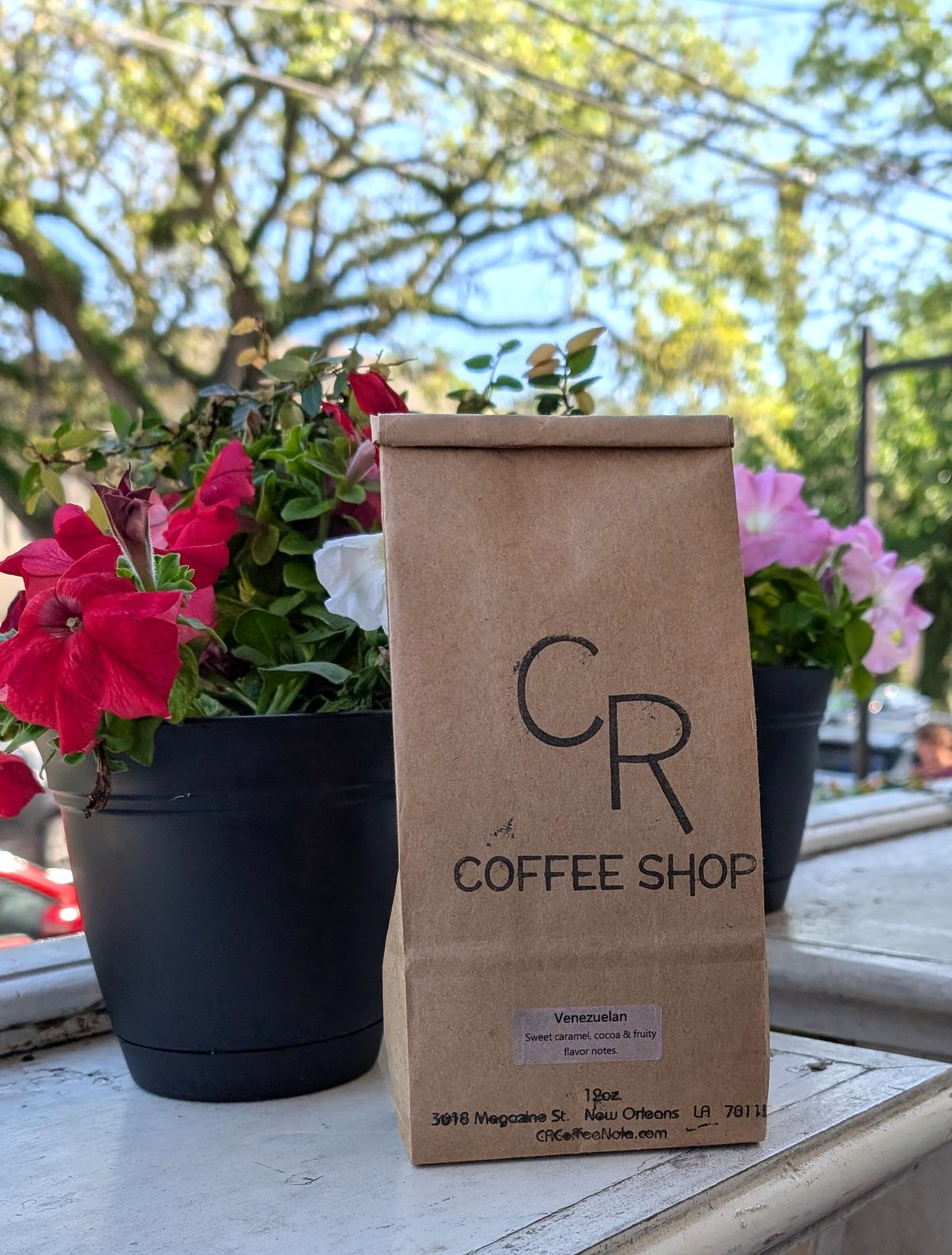CR Coffee Shop Venezuelan single origin coffee bag on a windowsill with flowers
