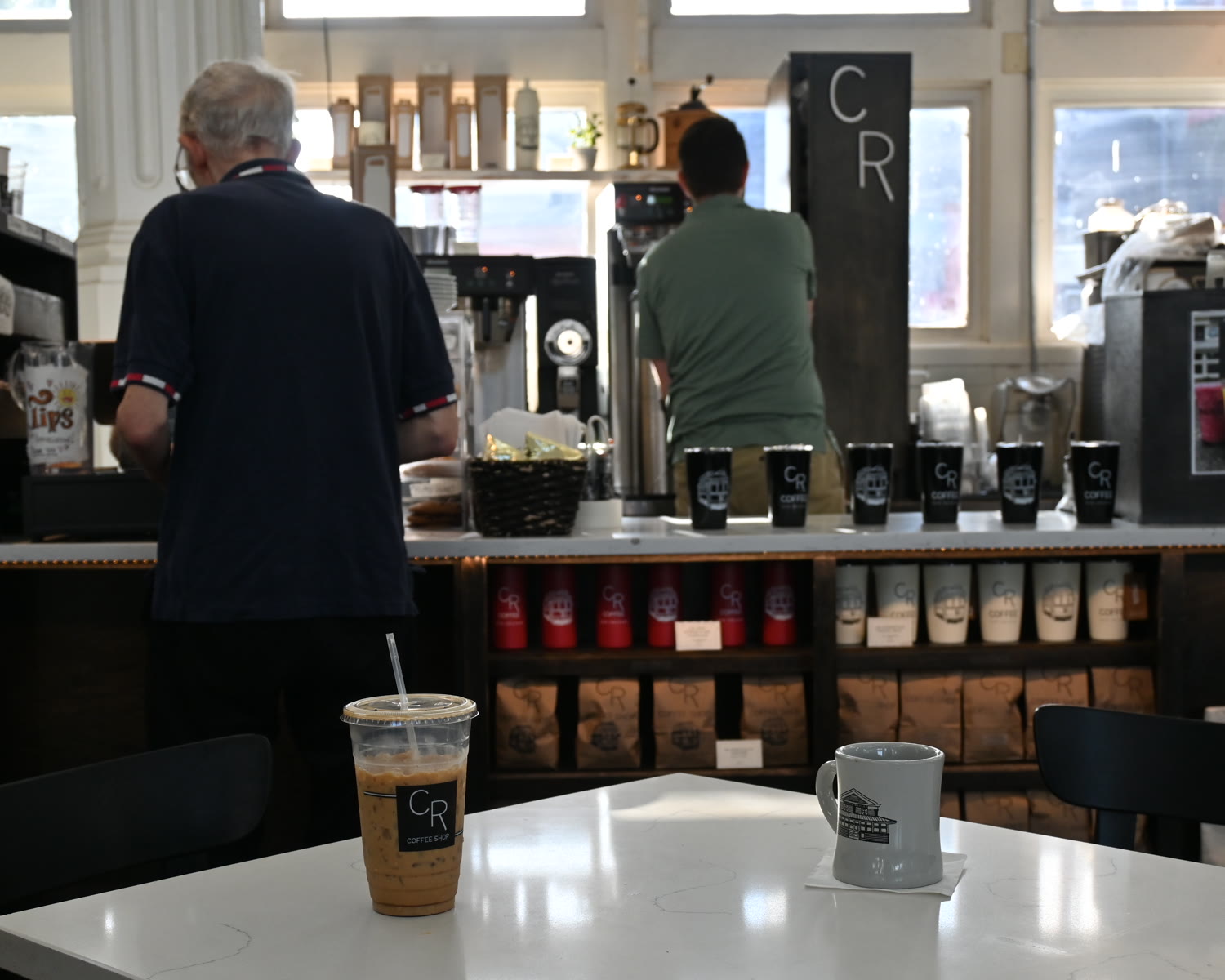 The CR counter inside St. Roch Market, stocked with fresh coffee bags and streetcar tumblers